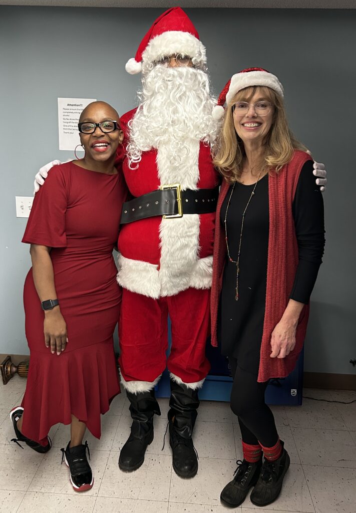 Annie Malone CEO, CEO Keisha Lee and Mitzi MacDonald with Santa Claus.